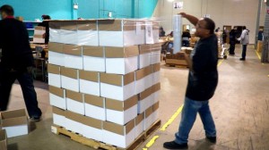 Workers shrink wrapping packages